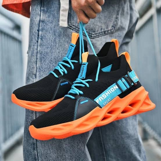 orange sneakers gladiator flashlander model holding shoes by shoelaces